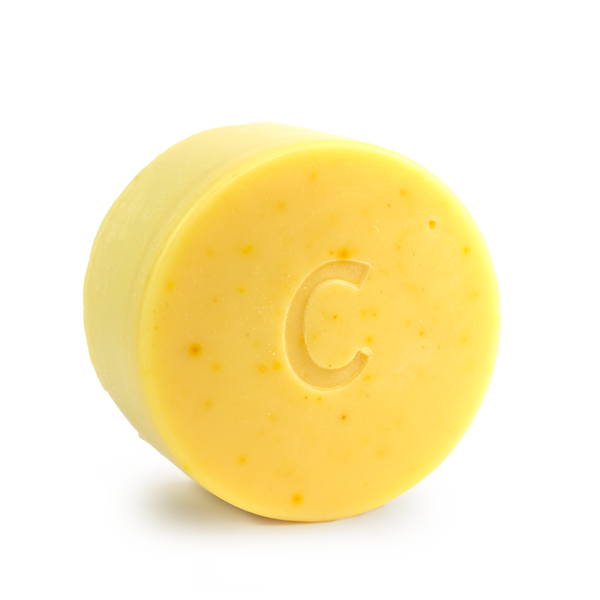 Citrus Shine conditioner bar for curly hair scented with orange bergamot and litsea cubeba essential oils contains calendula chamomile and turmeric all natural colour